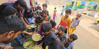 Children receiving warm meals on plates
